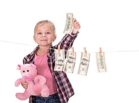 children and money. Girl hanging dollar bills on a rope isolated on white