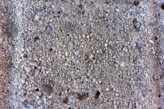 Texture of gray concrete with granite stones. gray abstract background. Natural stone texture. Close up.