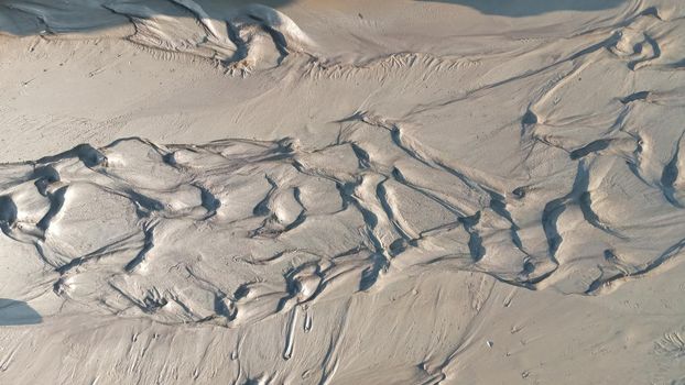 Dirty wet sand, grunge horizontal shabby background close-up. Blurry image of sand pattern. Abstract nature background.