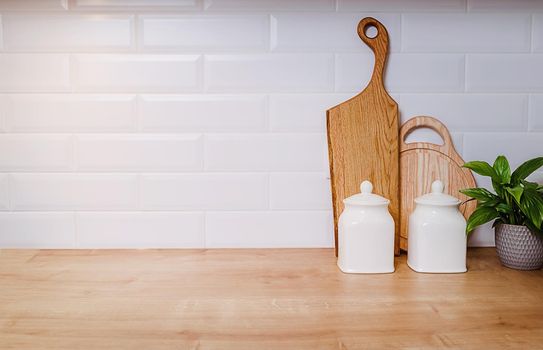 Template, vintage kitchen mockup with copy paste. Dishes, wooden boards and flowers culinary background. home cooking concept. Large empty piece of white wall, ceramic tile