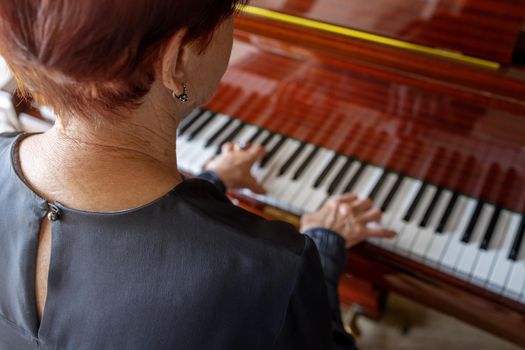 Old woman teaching piano