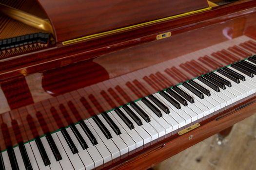 close-up, brown piano keys in the sun. Shallow depth of field. background for music banner or cover