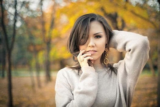 Autumn outdoor portrait of young beautiful mixed race woman 30 y. o.