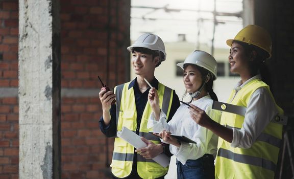 Professional Construction and Engineer team Working on workplace. Professional black architect and construction worker working look at blueprint plan on site..
