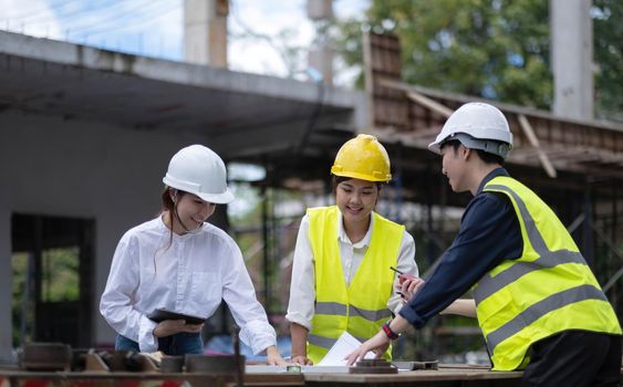 Three experts inspect commercial building construction sites, industrial buildings real estate projects with civil engineers, investors use laptops in background home, concrete formwork framing..