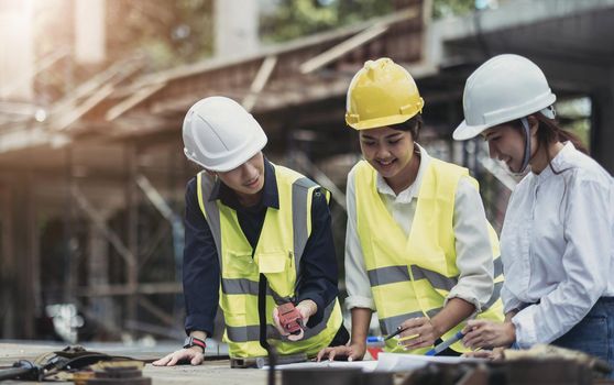 Three experts inspect commercial building construction sites, industrial buildings real estate projects with civil engineers, investors use laptops in background home, concrete formwork framing..