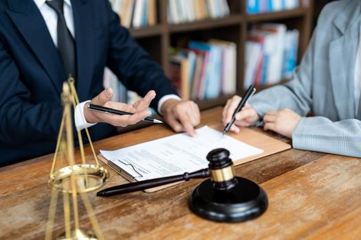 business people and lawyers discussing contract papers sitting at the table. Concepts of law, advice, legal services.