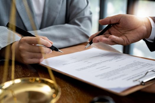 business people and lawyers discussing contract papers sitting at the table. Concepts of law, advice, legal services
