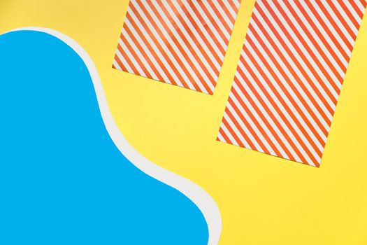 striped red beach towels on yellow sand beach and flat pool. Minimal paper summer concept. banner, copy space