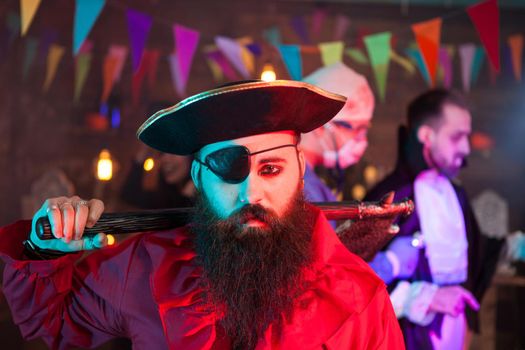 Portrait of handsome men dressed up like a sad pirate at halloween gathering. Attractive man in a pirate costume.