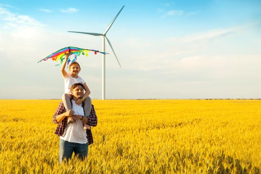 Happy father's day. Father and daughter having fun, playing with kite together on the Wheat Field on Bright Summer day