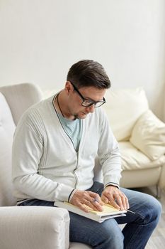 Waiting for patient. Friendly psychologist sitting with clipboard, in office, empty space