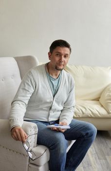 Waiting for patient. Friendly psychologist sitting with clipboard, in office, empty space