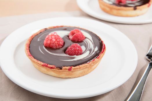 White and dark chocolate tartlet with raspberries.