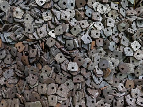 full-frame texture and background of many stamped parts after sand blasting