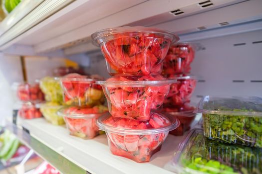 Healthy fruit and vegetables in grocery shop. Close up of fresh food in refrigerator.