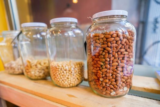 Close up image of jars with various seeds in vegan food shop.