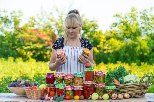 Woman with jar preserved vegetables for winter. Selective focus. Food.