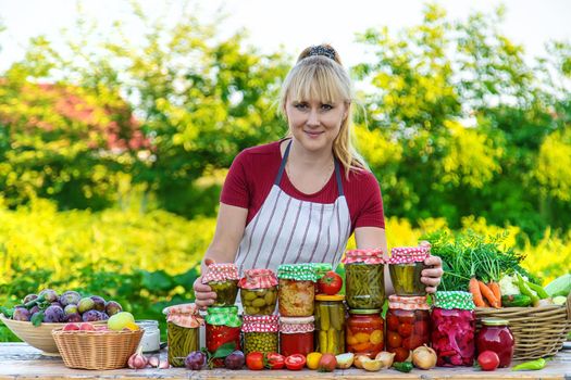 Woman with jar preserved vegetables for winter. Selective focus. Food.