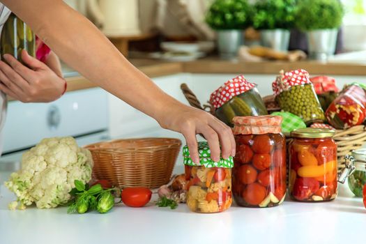 Woman jar preserve vegetables in the kitchen. Selective focus. Food.