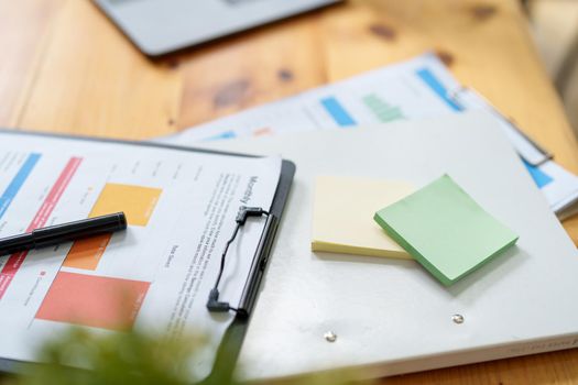 financial budget documents and notepads on the desk.