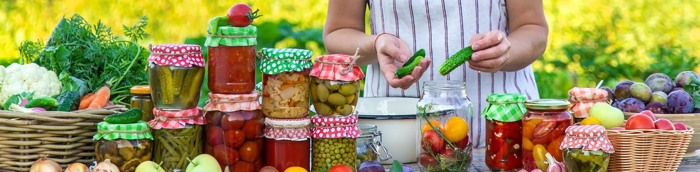 Woman with jar preserved vegetables for winter. Selective focus. Food.