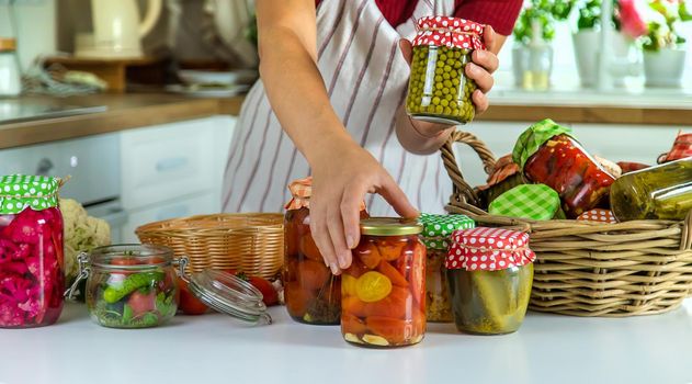 Woman jar preserve vegetables in the kitchen. Selective focus. Food.