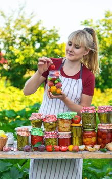 Woman with jar preserved vegetables for winter. Selective focus. Food.