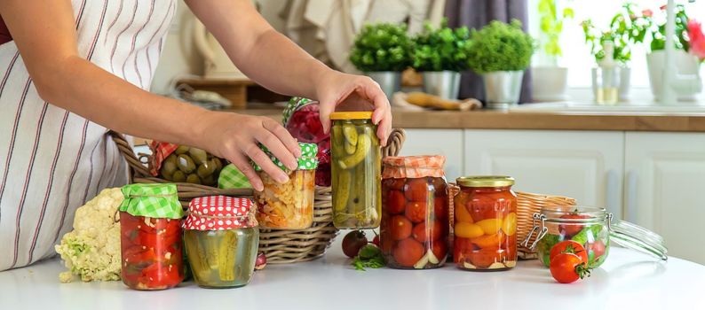 Woman jar preserve vegetables in the kitchen. Selective focus. Food.