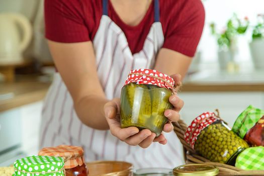 Woman jar preserve vegetables in the kitchen. Selective focus. Food.