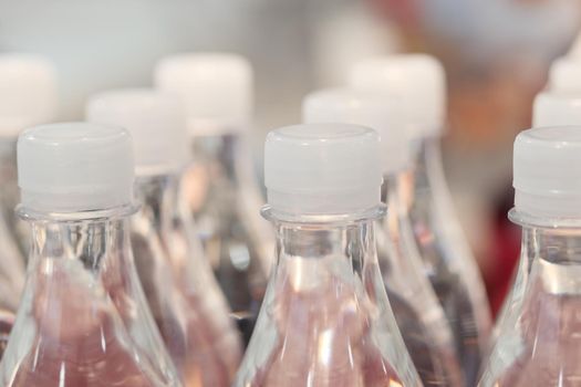 plastic bottles of soft drink on table .