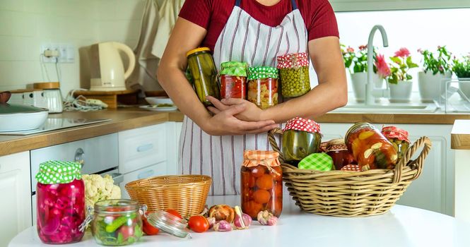 Woman jar preserve vegetables in the kitchen. Selective focus. Food.