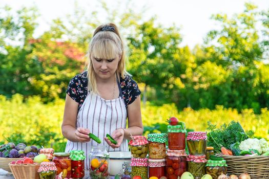 Woman with jar preserved vegetables for winter. Selective focus. Food.