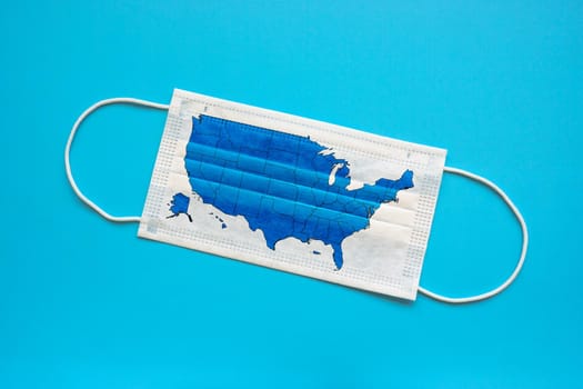 Medical protective mask and map of USA on it as a symbol of quarantine.