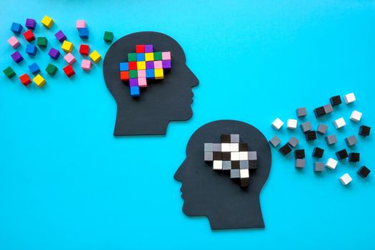 Positive and negative mindset concept. Heads with small colorful cubes.