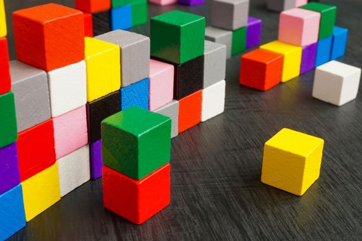 Multicolored cubes on the surface as a symbol of complexity, diversity and integration.