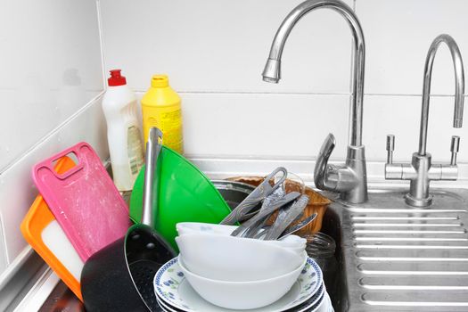 Dirty dishes in the kitchen sink. Handwashing concept. High quality photo