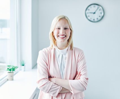 portrait of a young business woman holding a in the office