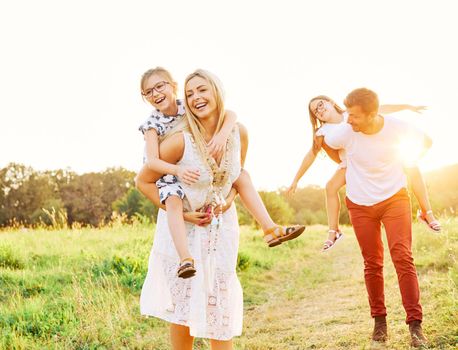 Portrait of a young happy family having fun outdoors