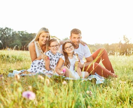 Portrait of a young happy family having fun outdoors