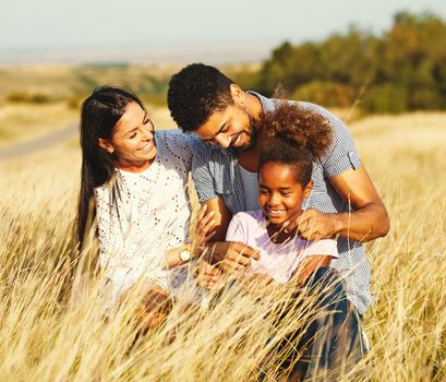 Family having fun outdoors in meadow