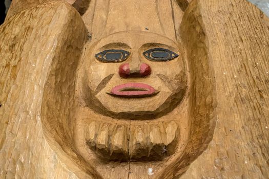 Ketchikan, AK - 10 June 2022: New carving of a face on a Totem pole in Potlatch Park in Alaska