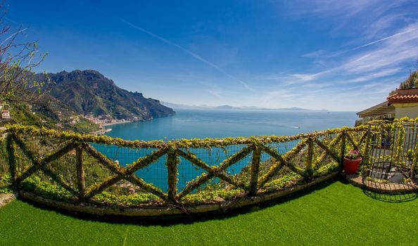 Aerial view of Ravello with comfortable beach and blue sea on Amalfi Coast in Campania, Italy. Amalfi coast is popular travel and holiday destination in Europe. Ripe yellow lemons in foreground.