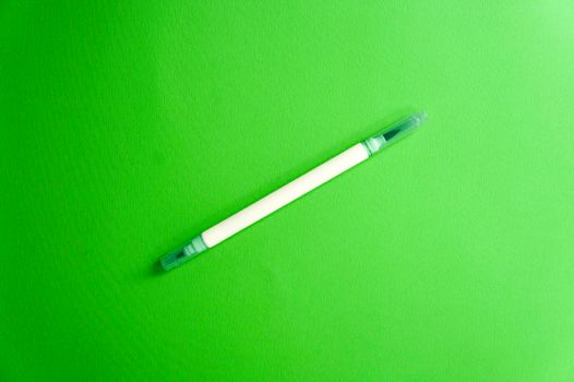 Emerald green marker on a green background, a fresh mood. Back to school. Double sided art marker. Color mood