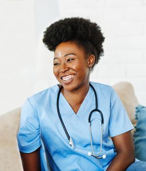 Portrait of a young female nurse caregiver in a nursing home or visit in household