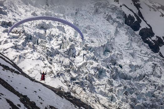 Paragliding over Glacier Bossons in Haute Savoie, Chamonix, French Alps, Eastern France