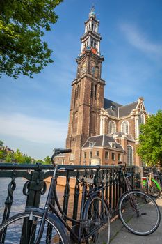 Amsterdam canal with bicycles and dutch architecture at sunrise, Netherlands