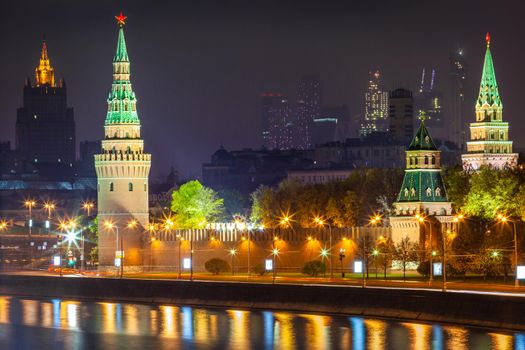 Kremlin towers illuminated at evening with river Moscva reflection, Moscow, Russia