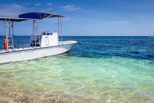 Translucent caribbean beach with motorboat, Negril Seven Mile Beach, Jamaica