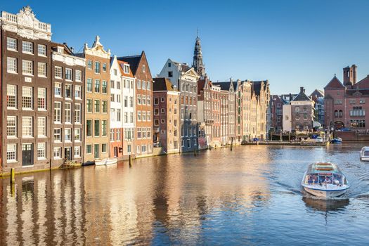 Amsterdam canal with houseboats and dutch architecture at sunrise, Netherlands